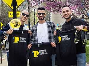 student holding branded merchandise