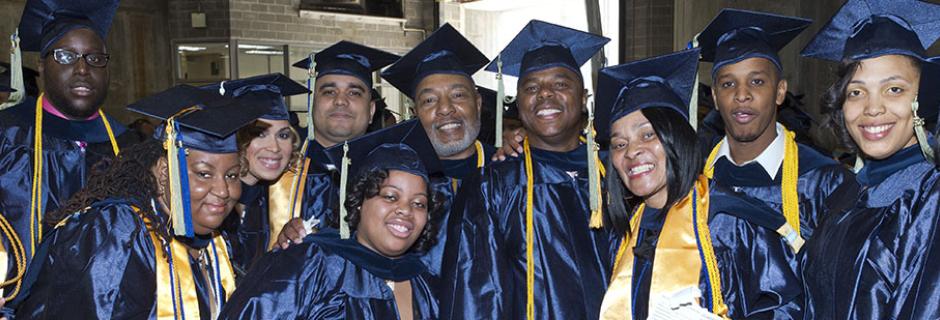 A group of students in caps and gowns on graduation day.