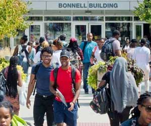 Crowd of students walking outside in front of the Bonnell building.